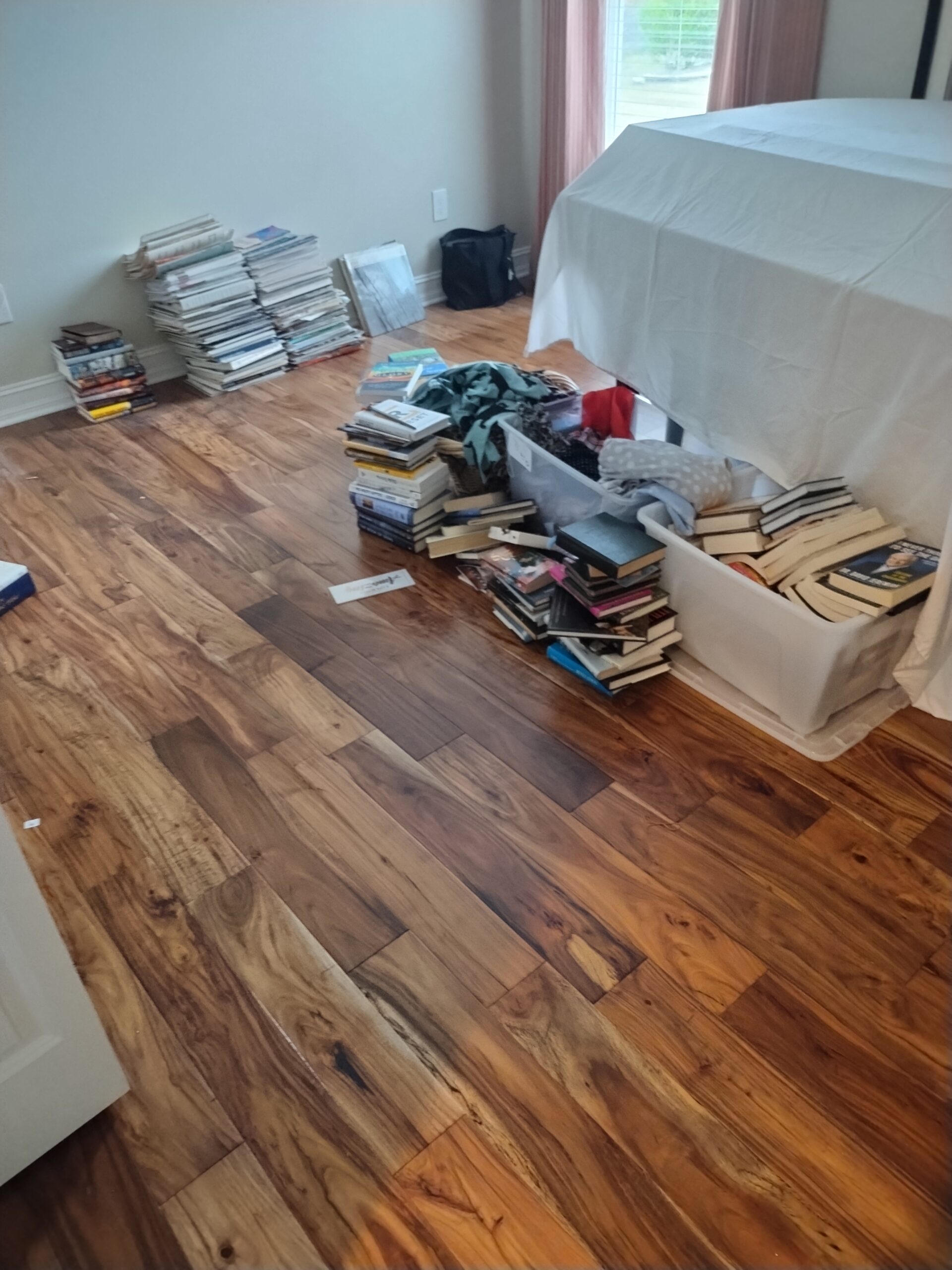 Cluttered bedroom with piles of books and junk on bed during hoarder cleanout in Citrus Hills Florida