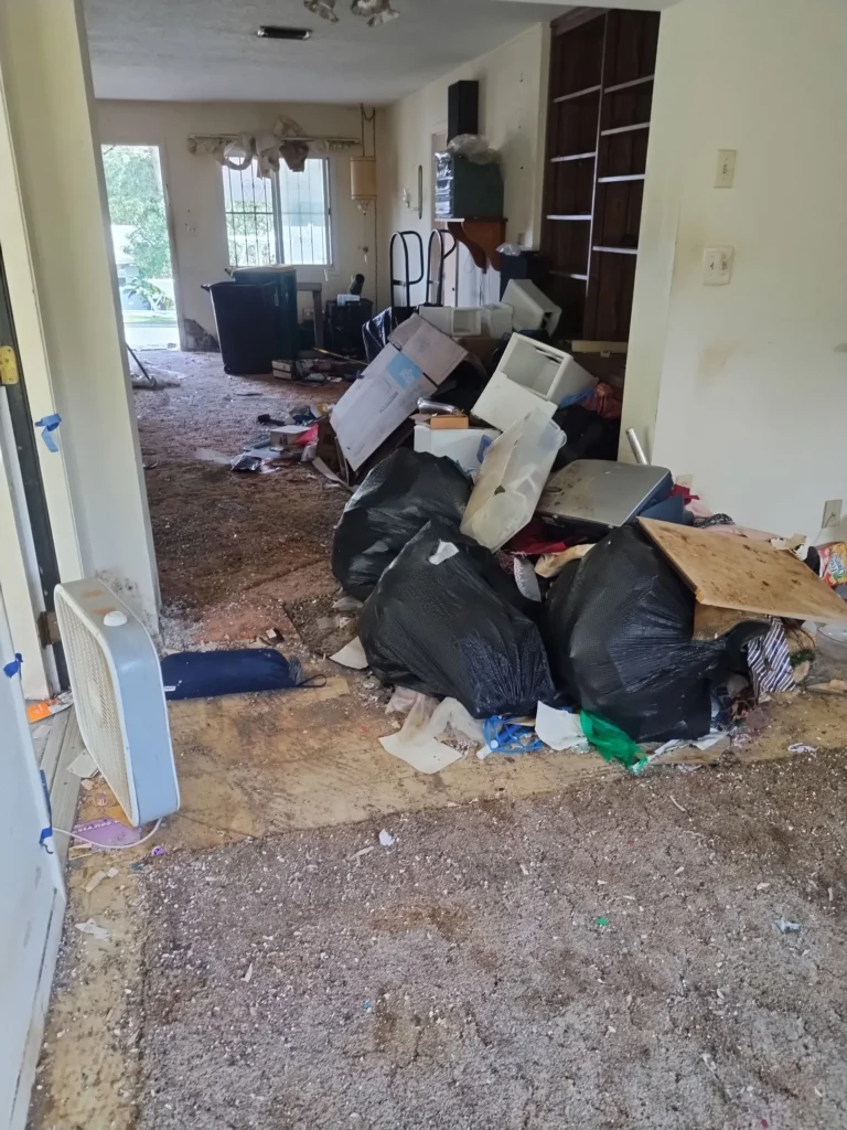 Home with clutter and piled up junk that is being cleaned and hauled away